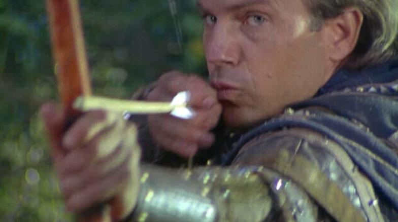 Kevin Costner as Robin Hood shoots an arrow
