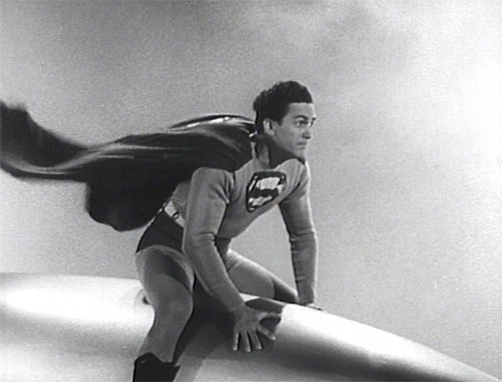Superman (Kirk Alyn) riding a missle or rocket