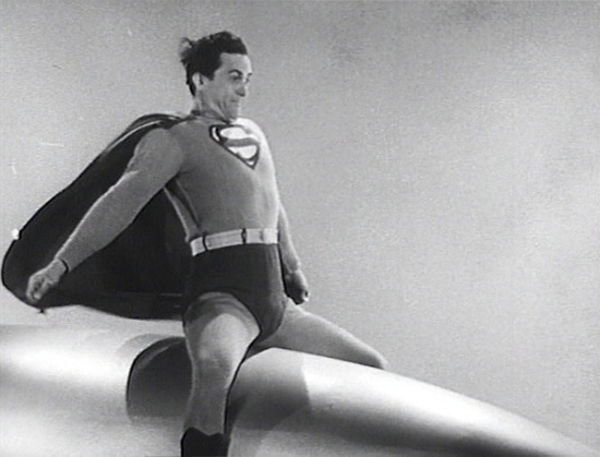 Superman (Kirk Alyn) riding a missle or rocket